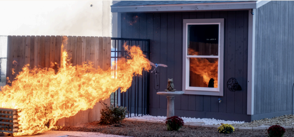 burning fence attached to home